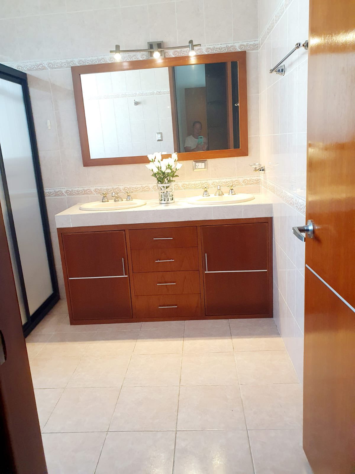 Baño con doble lavabo y acabados modernos en madera.